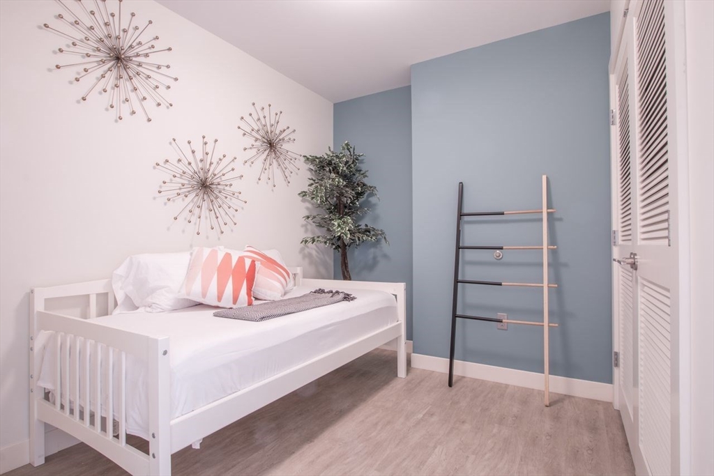 900 Beacon Street, Unit 408 Boston, MA 02215 - Photo 12 of 12 a bedroom with a bed and a potted plant