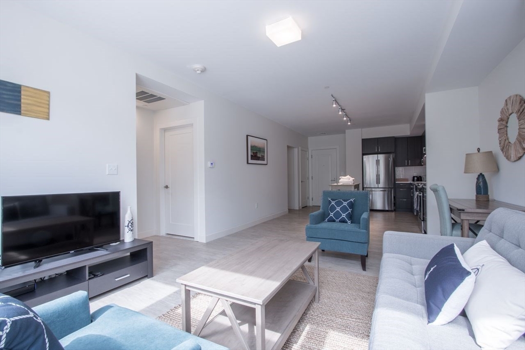 900 Beacon Street, Unit 408 Boston, MA 02215 - Photo 4 of 12 a living room with furniture and a flat screen tv