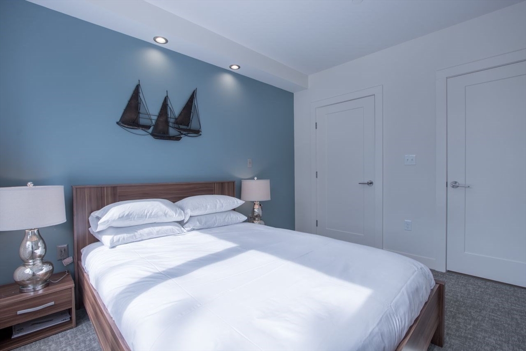 900 Beacon Street, Unit 408 Boston, MA 02215 - Photo 9 of 12 a bedroom with a bed and a night stand