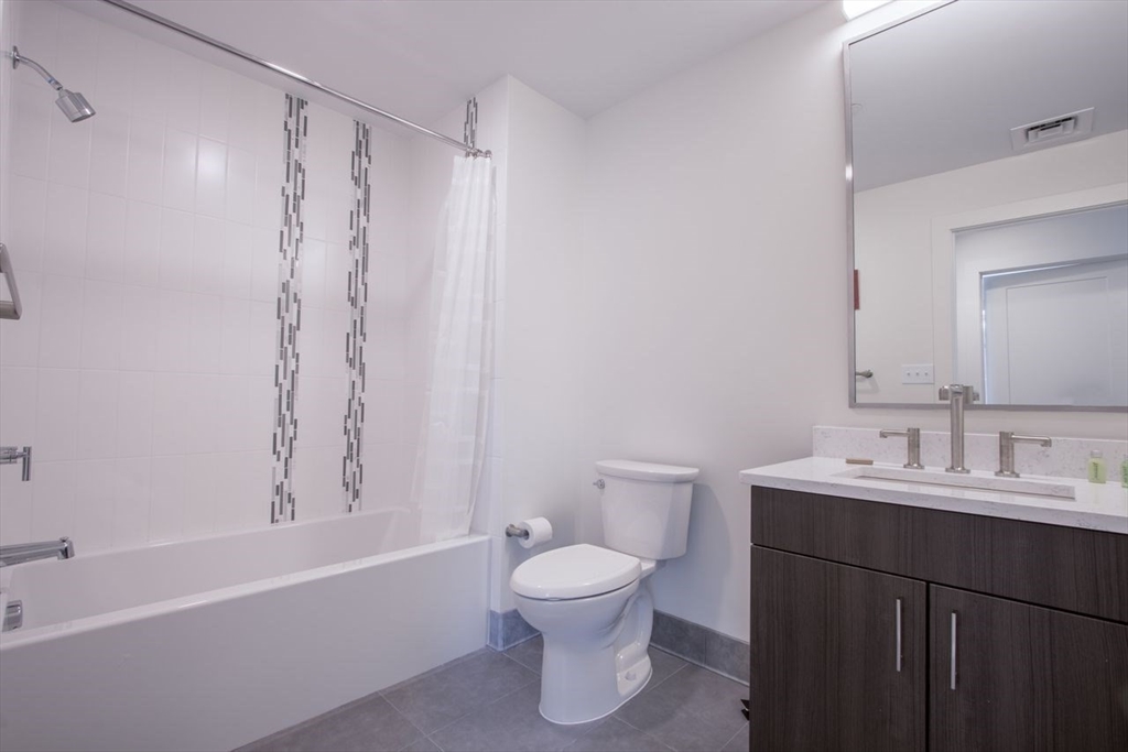 900 Beacon Street, Unit 408 Boston, MA 02215 - Photo 10 of 12 a bathroom with a toilet a sink and a bathtub