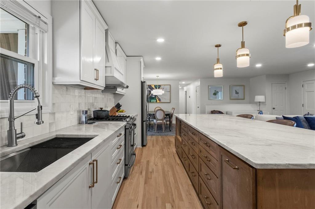 4061 North Cooper Lake Road Southeast Smyrna, GA 30082 - Photo 11 of 45 a large kitchen with stainless steel appliances granite countertop a lot of counter space and wooden floors