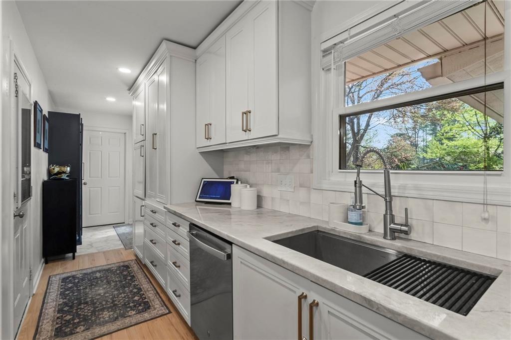 4061 North Cooper Lake Road Southeast Smyrna, GA 30082 - Photo 13 of 45 a kitchen with stainless steel appliances a sink stove and cabinets