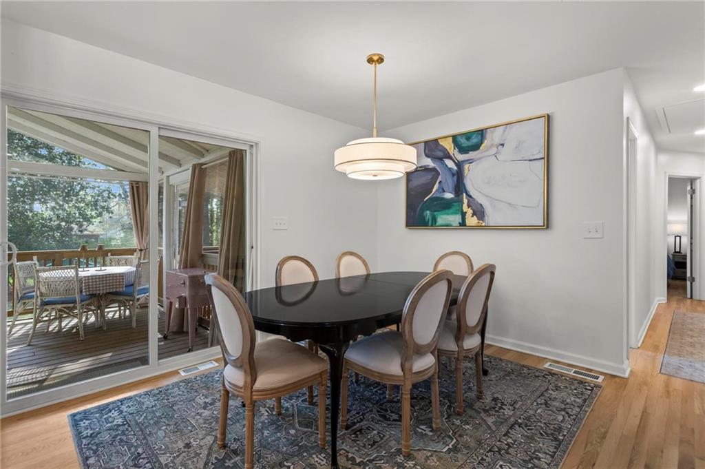 4061 North Cooper Lake Road Southeast Smyrna, GA 30082 - Photo 15 of 45 a dining room with furniture a chandelier and wooden floor