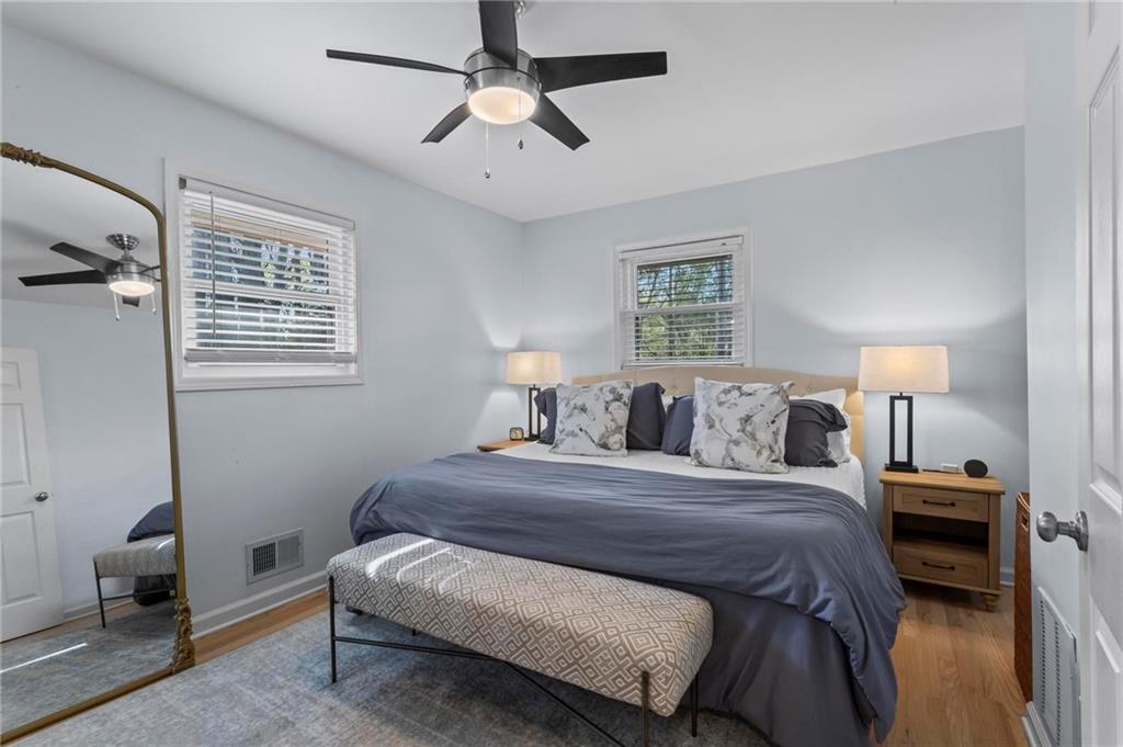 4061 North Cooper Lake Road Southeast Smyrna, GA 30082 - Photo 17 of 45 a bedroom with a bed chandelier and a window