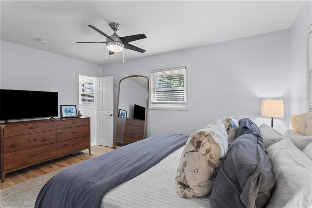 4061 North Cooper Lake Road Southeast Smyrna, GA 30082 - Photo 18 of 45 a bedroom with a bed and a flat screen tv