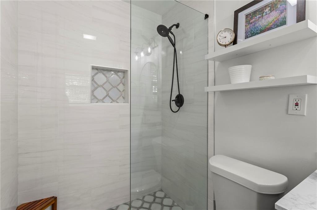 4061 North Cooper Lake Road Southeast Smyrna, GA 30082 - Photo 21 of 45 a white toilet sitting next to a shower