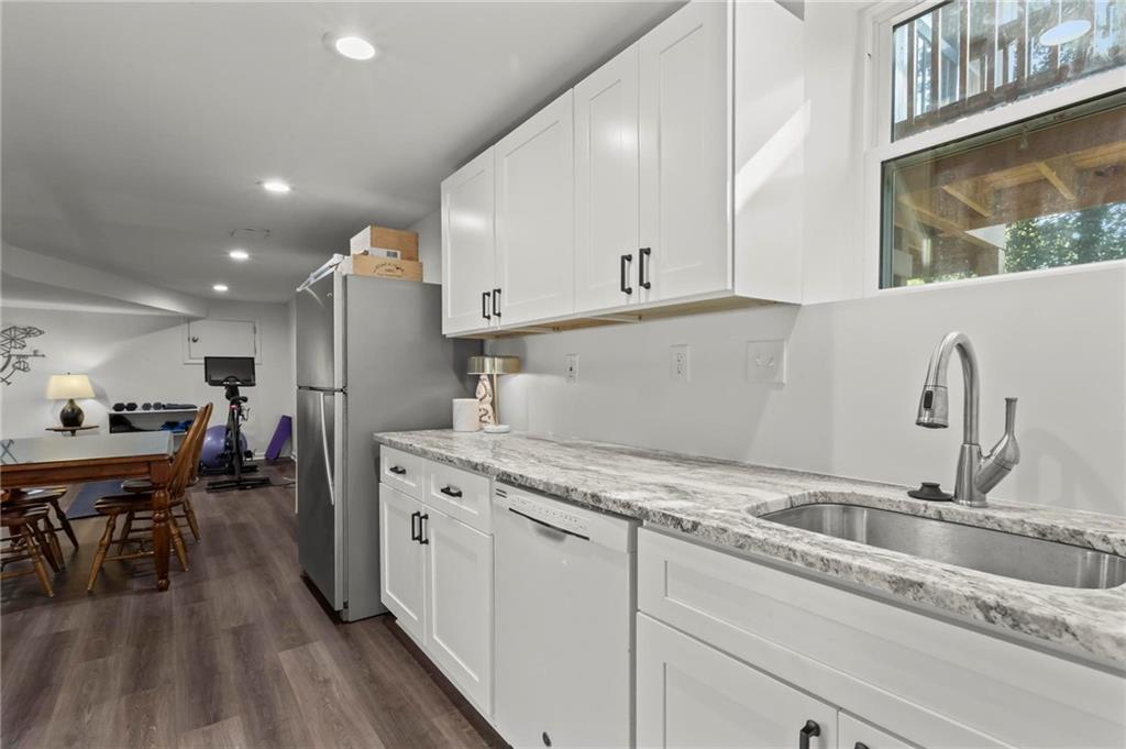 4061 North Cooper Lake Road Southeast Smyrna, GA 30082 - Photo 29 of 45 a kitchen with a sink stainless steel appliances and cabinets
