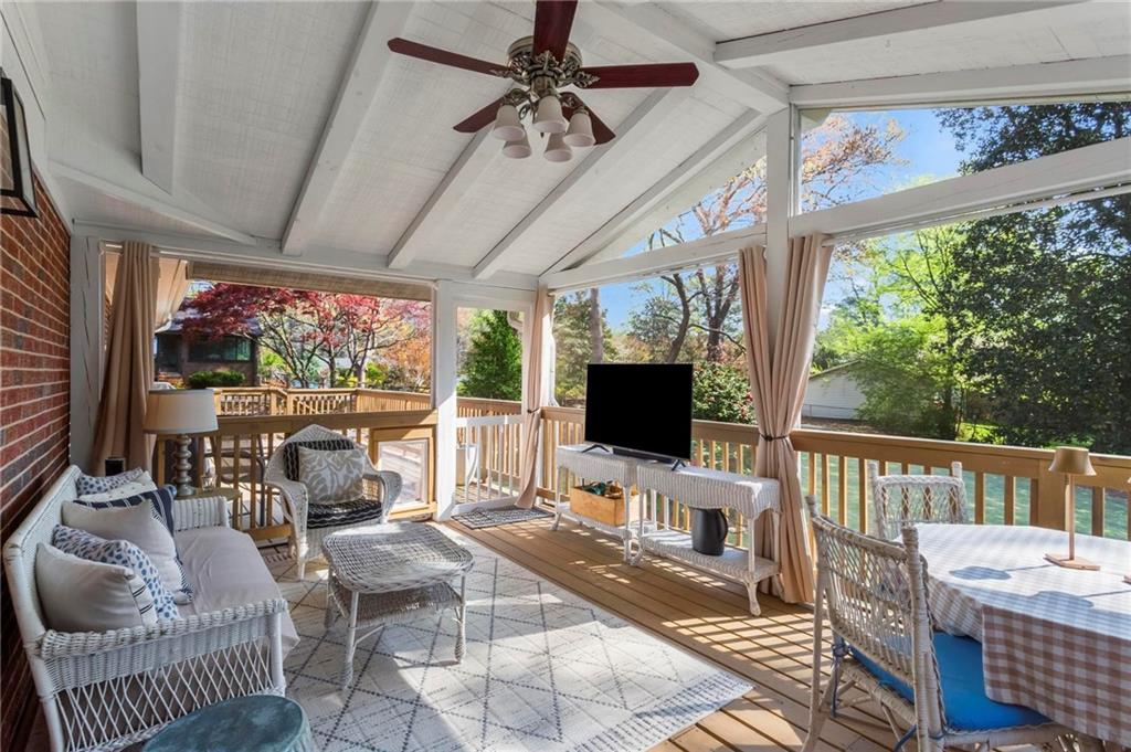 4061 North Cooper Lake Road Southeast Smyrna, GA 30082 - Photo 34 of 45 a living room with furniture a flat screen tv and a floor to ceiling window