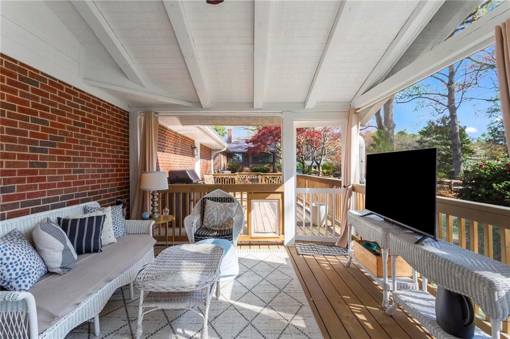 4061 North Cooper Lake Road Southeast Smyrna, GA 30082 - Photo 35 of 45 a living room with furniture a flat screen tv and floor to ceiling window