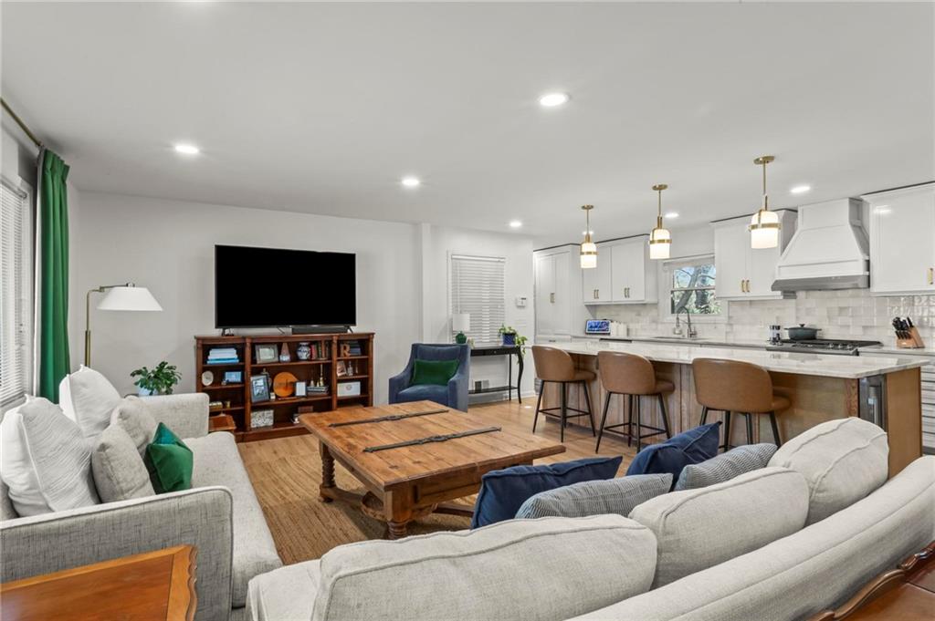4061 North Cooper Lake Road Southeast Smyrna, GA 30082 - Photo 4 of 45 a living room with furniture kitchen view and a flat screen tv