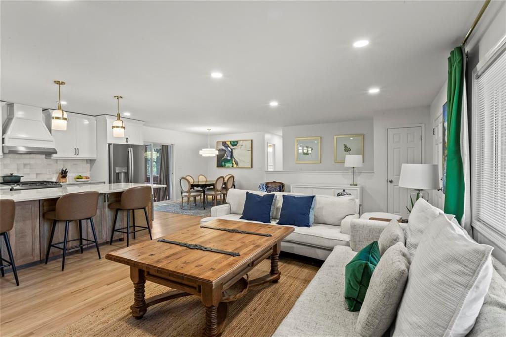 4061 North Cooper Lake Road Southeast Smyrna, GA 30082 - Photo 6 of 45 a living room with furniture a rug and kitchen view