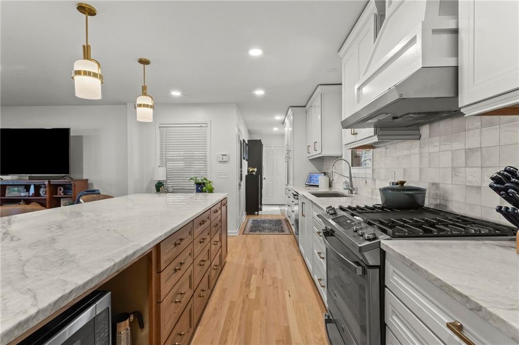 4061 North Cooper Lake Road Southeast Smyrna, GA 30082 - Photo 8 of 45 a kitchen with granite countertop a stove and a sink