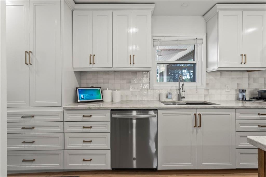 4061 North Cooper Lake Road Southeast Smyrna, GA 30082 - Photo 10 of 45 a kitchen with granite countertop white cabinets and white appliances
