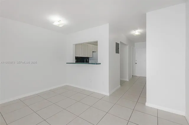 an empty room with white walls and tiles