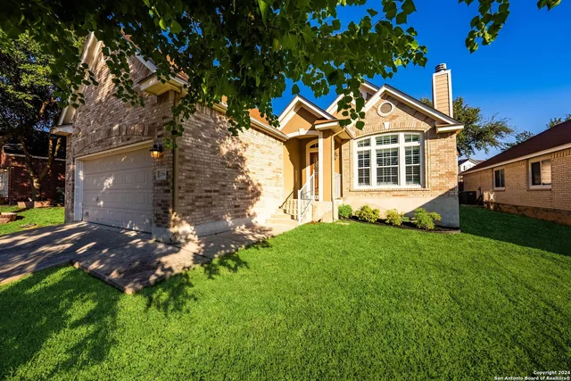 a front view of house with yard and green space