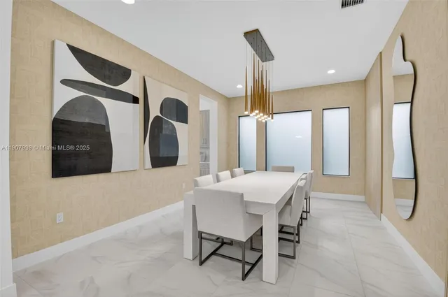 a kitchen with a refrigerator and a dining table