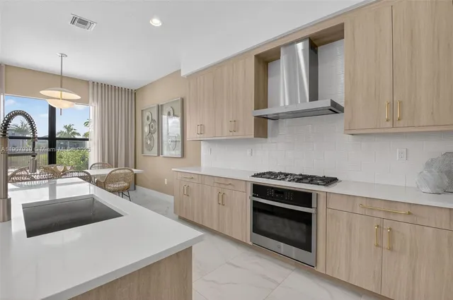 a living room with furniture a flat screen tv and a large window