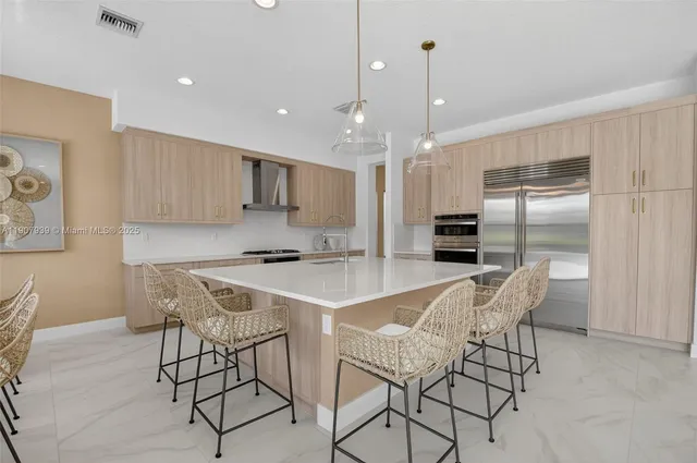 a living room with furniture a flat screen tv and a chandelier