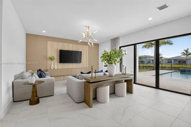 a bedroom with a bed lamp and a large window