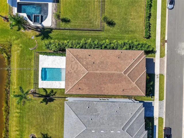 a view of a swimming pool with a chair and tables on the roof