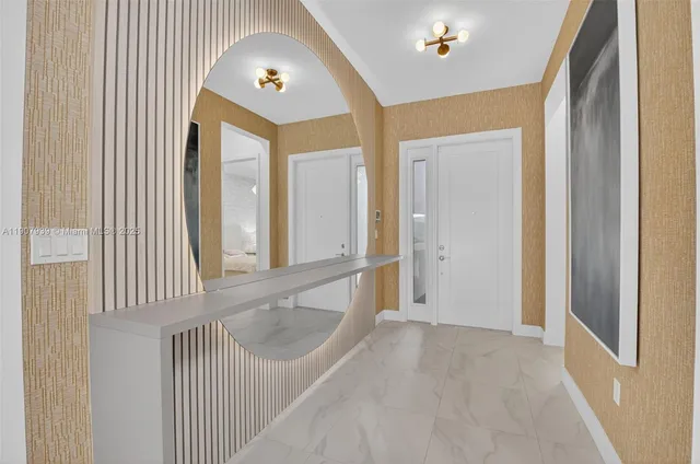 a living room with furniture a large window and a chandelier