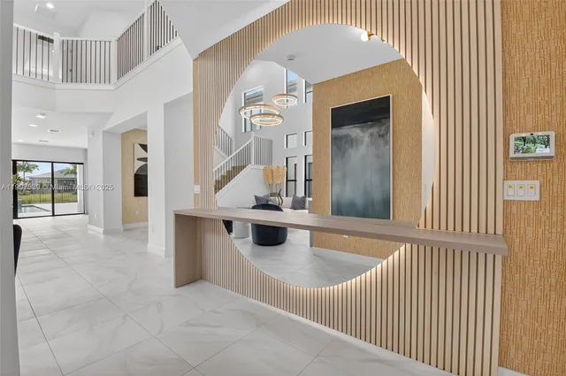 a dining room with furniture and a floor to ceiling window