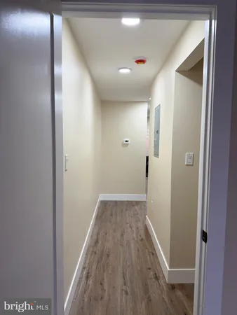 a view of hallway with wooden floor