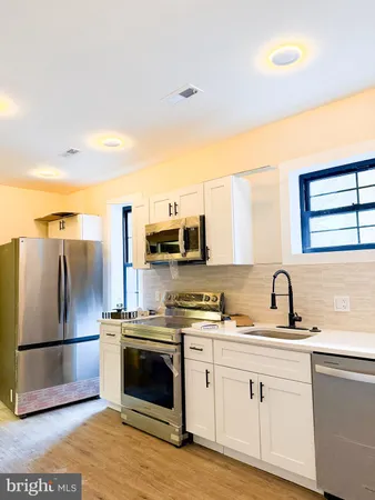 a kitchen with stainless steel appliances granite countertop a sink and cabinets