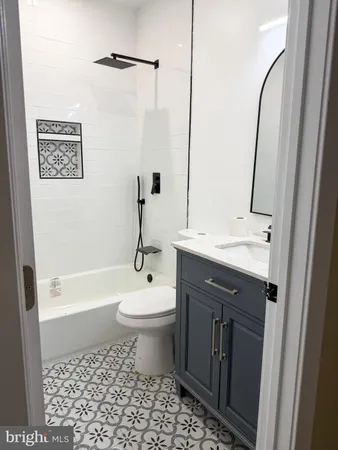 a bathroom with a sink vanity granite and a mirror
