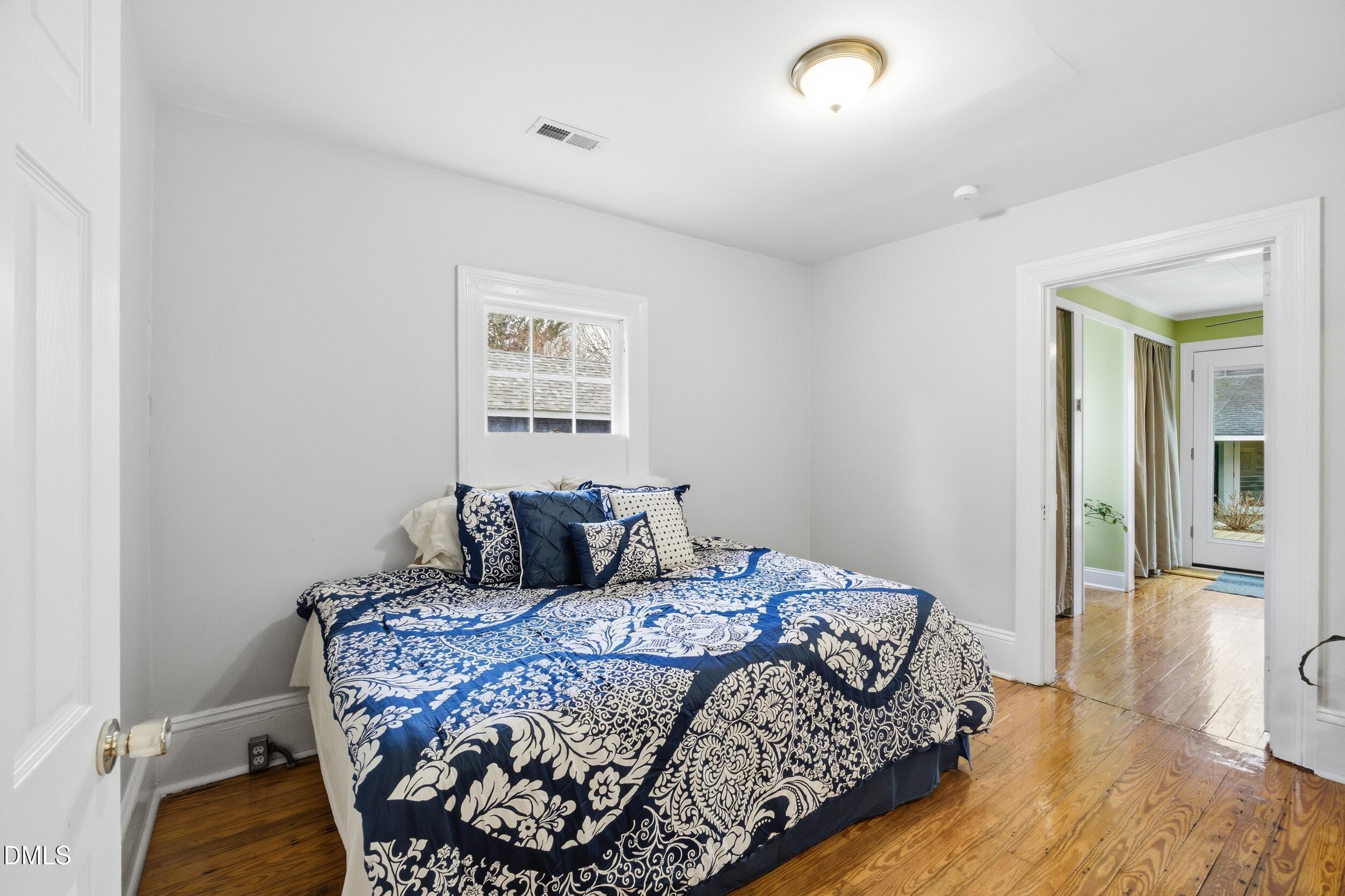 700 Sasser Street Raleigh, NC 27604 - Photo 10 of 25 a bedroom with a bed and wooden floor