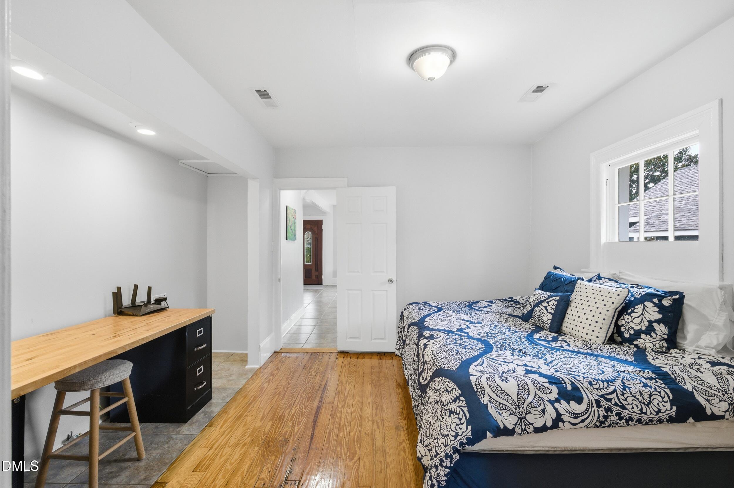 700 Sasser Street Raleigh, NC 27604 - Photo 12 of 25 a bedroom with a bed and wooden floor