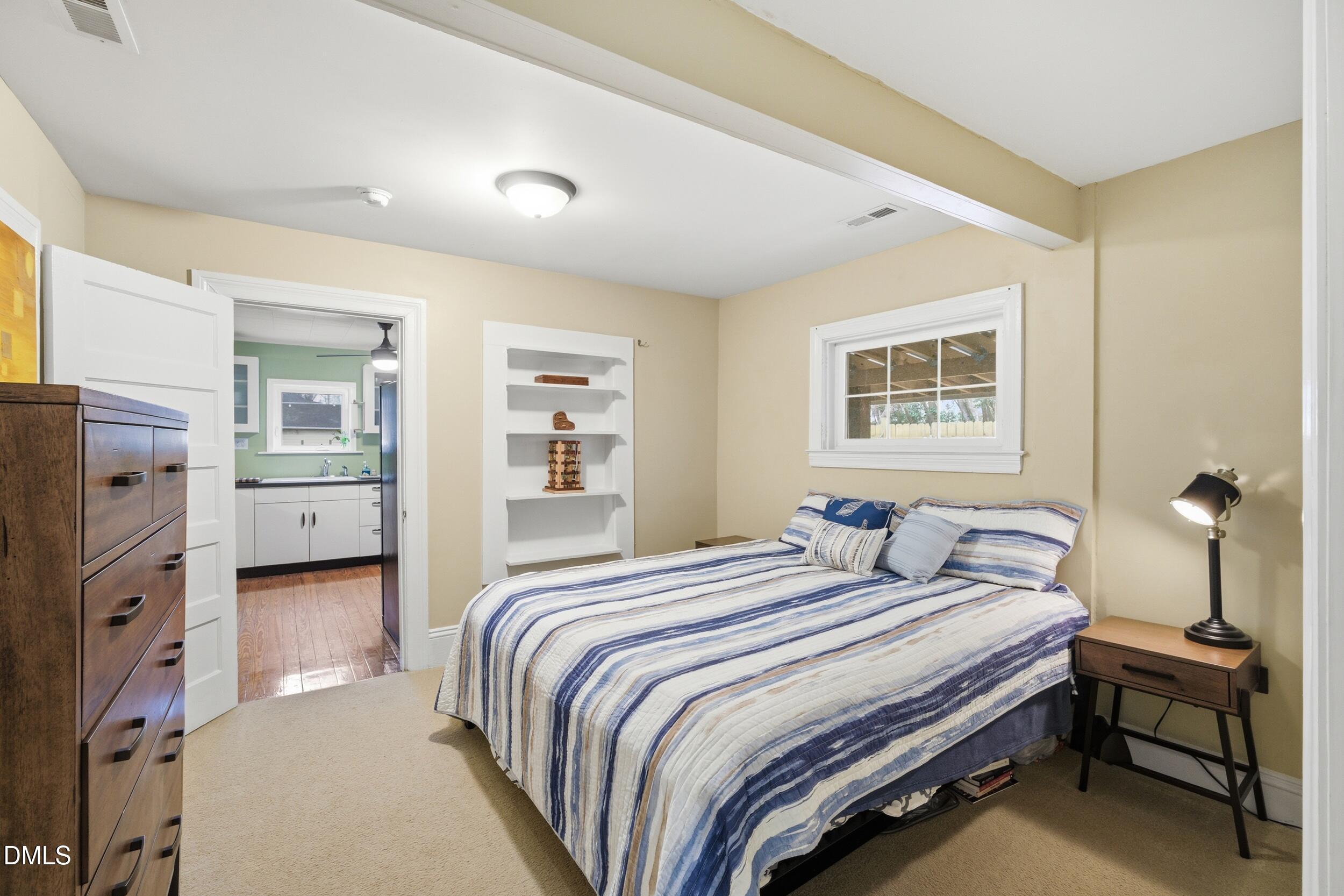 700 Sasser Street Raleigh, NC 27604 - Photo 16 of 25 a bedroom with a bed and a cabinets