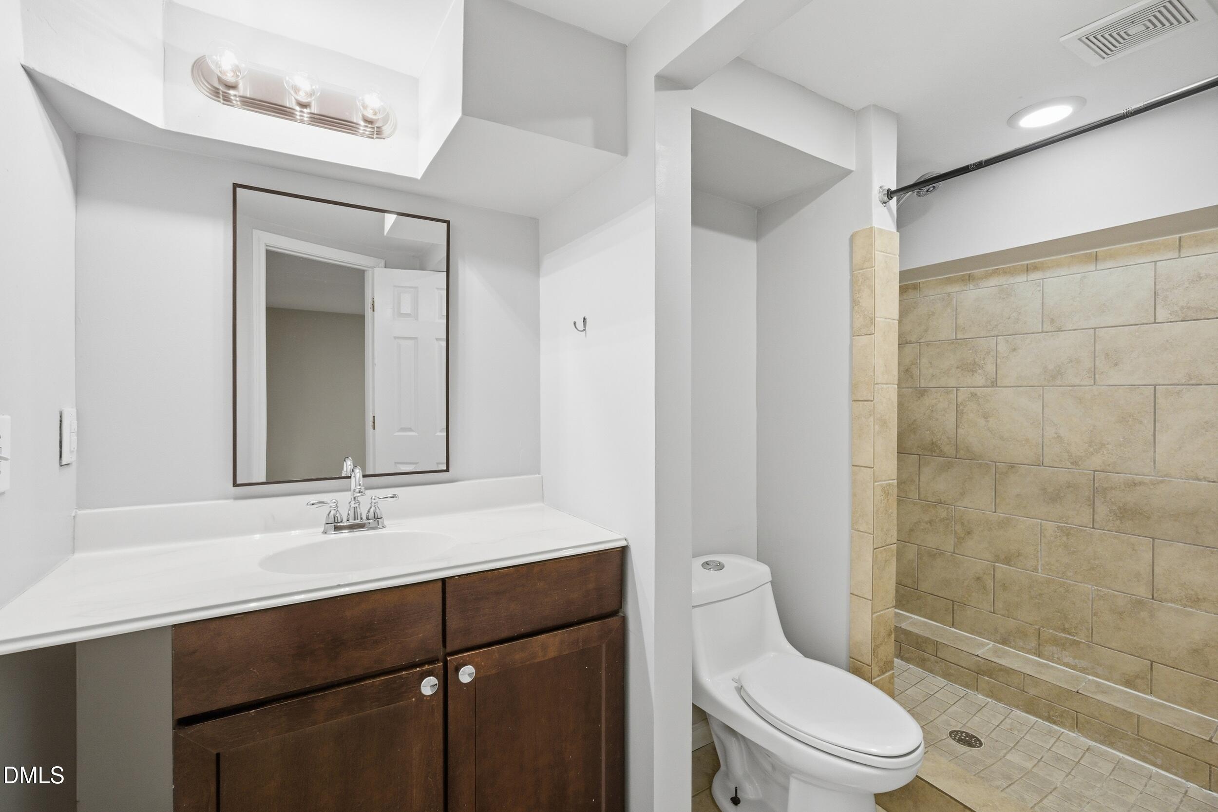 700 Sasser Street Raleigh, NC 27604 - Photo 19 of 25 a bathroom with a sink a toilet and shower
