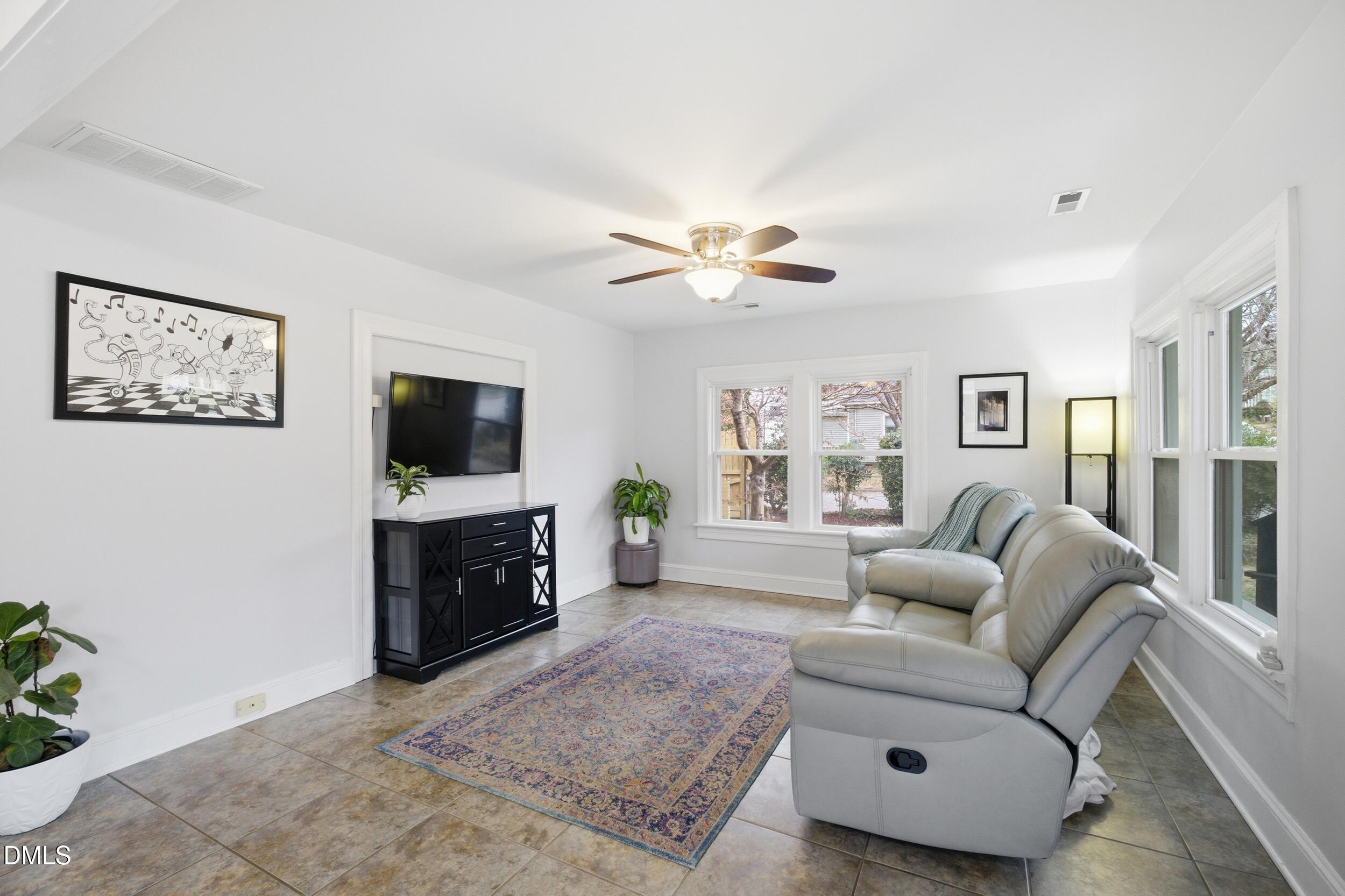 700 Sasser Street Raleigh, NC 27604 - Photo 8 of 25 a living room with furniture and a flat screen tv