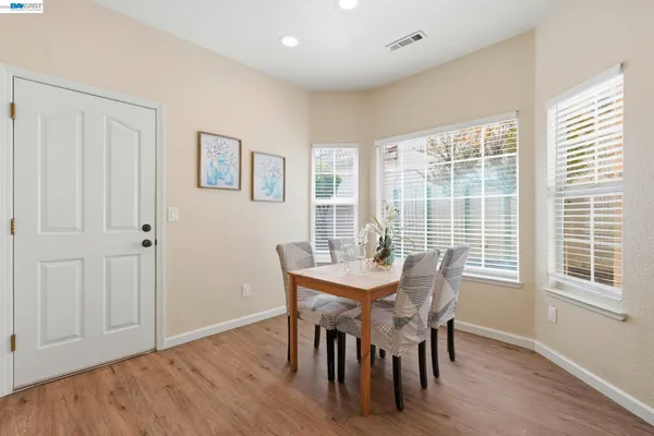 a view of a dining room with furniture and wooden floor
