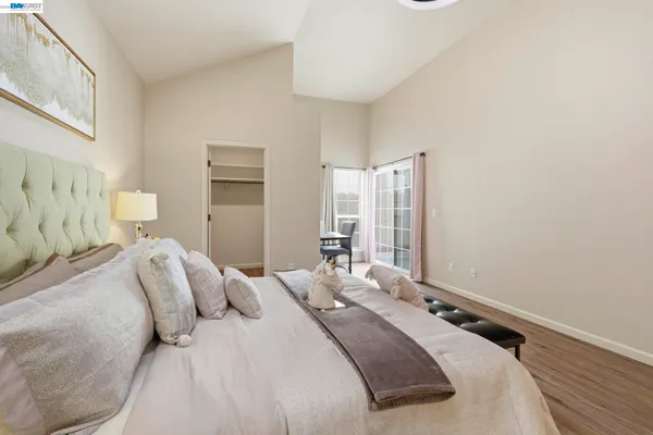 a bedroom with a bed and a window