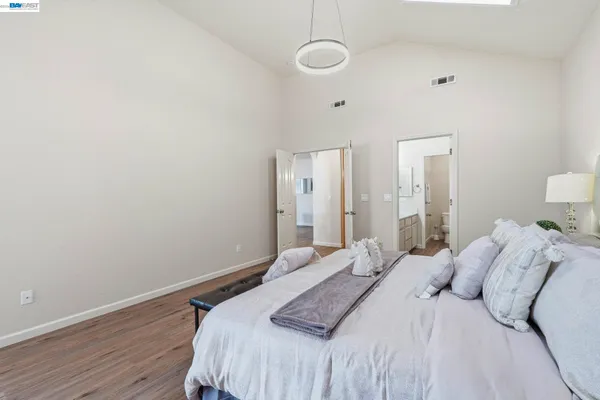 a bedroom with a bed and a night stand