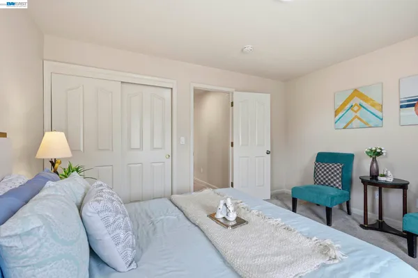 a bedroom with a bed and a chair