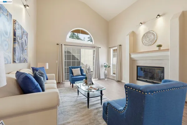 a living room with furniture a clock and a fireplace