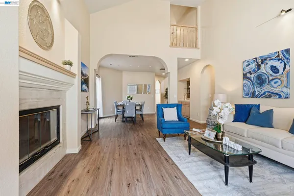 a living room with furniture a fireplace and wooden floor