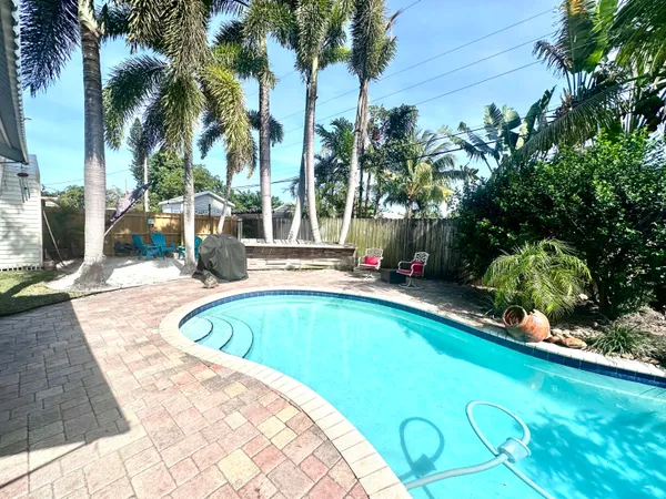 a swimming pool with outdoor seating and yard