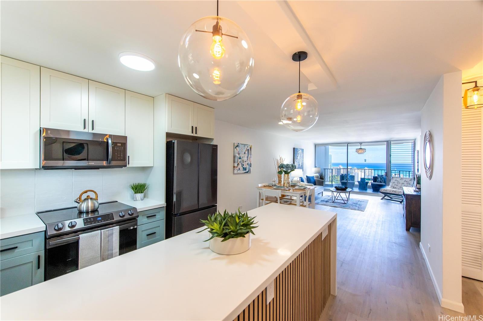 469 Ena Road, Unit 2908 Honolulu, HI 96815 - Photo 1 of 1 a kitchen with sink refrigerator and microwave