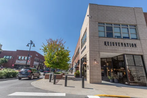a view of a street with a building and a street sign