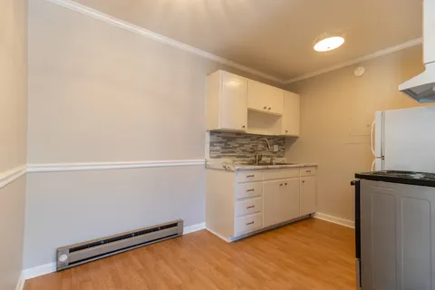 a room with a refrigerator and cabinets