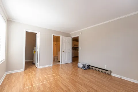 an empty room with wooden floor and closet