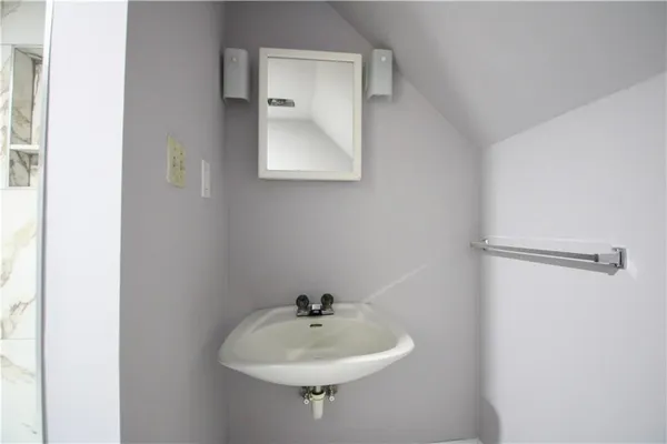 a bathroom with a sink and mirror