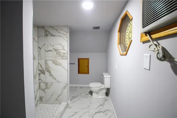 a bathroom with a toilet sink and mirror