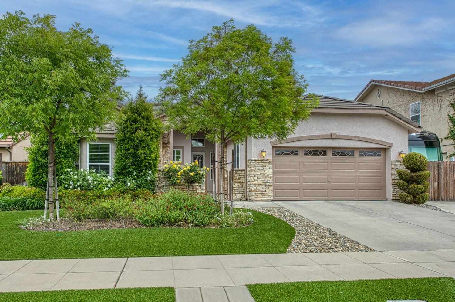 front view of a house with a garden