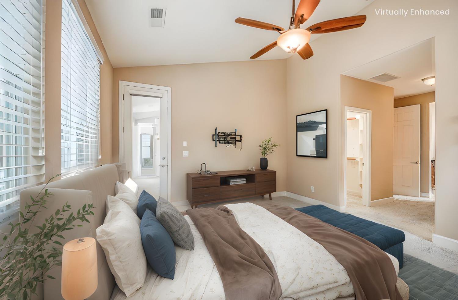 2267 Graybark Avenue Clovis, CA 93619 - Photo 11 of 42 a bedroom with a large bed and a chandelier