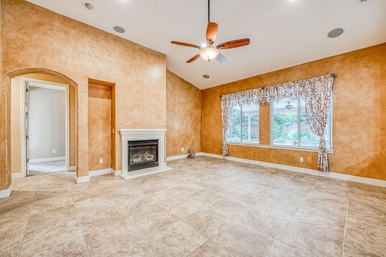 2267 Graybark Avenue Clovis, CA 93619 - Photo 12 of 42 a view of an empty room with a window and fireplace